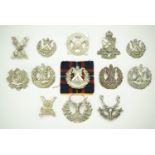 A group of Scottish regimental cap badges together with two sporran badges