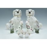 A pair of Staffordshire style spaniels, a pair of Victorian small sponge ware cats, a pair of late