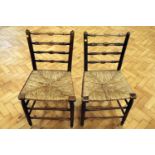 A pair of 19th Century rush-seated ladder-back chairs