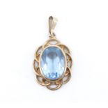 A mid 20th Century aquamarine pendant, having an oval stone 14 x 10 mm in a 9 ct gold rubbed setting