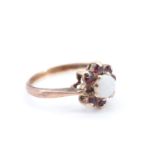 An opal and garnet flowerhead cluster ring, the opal cabochon of 5 mm diameter, set on 9 ct gold, M,