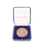 A 1959 Harrods, Sir Richard Burbidge bronze medallion, cased together with presentation card bearing