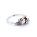 A vintage two-stone diamond ring, comprising a pair of old cut stones each of approx 0.5 ct, twist-