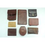 A group of leather and hide stud cases, wallets etc