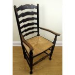A rush-seated ladder-back armchair