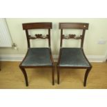 A pair of reproduction Regency style mahogany sabre-legged dining chairs