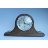A 1950s oak "Napoleon hat" mantle clock, 43 cm x 25 cm