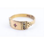 An Edwardian ruby and seed pearl finger ring, the head of the ring being an oblong set with a