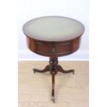 A reproduction Georgian mahogany small drum-top tripod table, having an inset gilt-tooled green