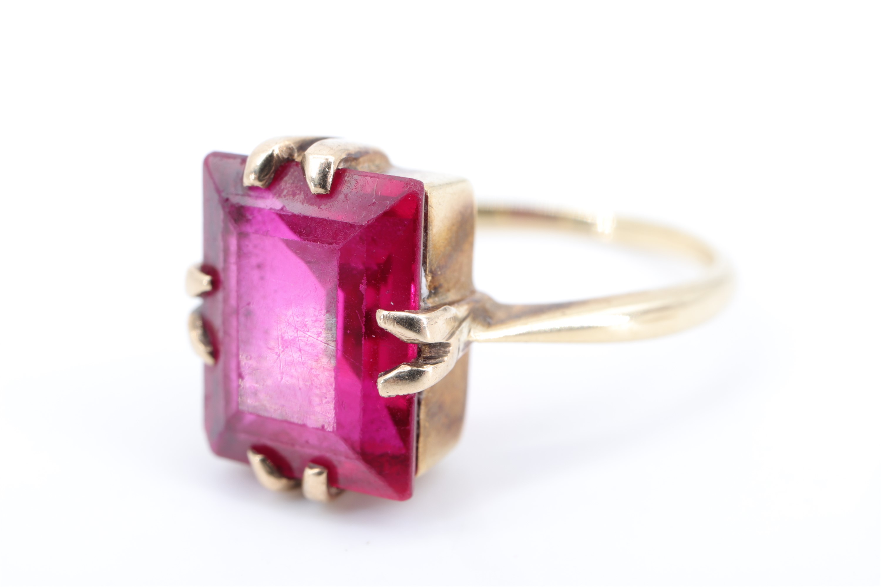 A vintage ruby cocktail ring, the baguette-cut stone of approx 4 ct, claw-set on a rectangular