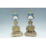 A pair of late 19th Century Sevres style porcelain garniture urns and stands, 34 cm