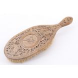 An finely carved early 20th Century hairbrush, having renaissance influenced decoration, 19.5 x 7