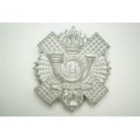 A Highland Light Infantry plastic cap badge