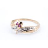A contemporary 9 ct gold serpent ring, set with a diamond, the snake having pink gemstone eyes, Q,