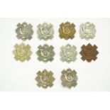 A collection of Highland Light Infantry cap badges including a 1st Volunteer Battalion example