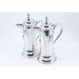 A pair of late Victorian silver wine ewers, of cylindrical form with a reeded top edge and a