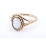 A lady's opal and 9 ct gold finger ring, having an oval opal in a rubbed over setting within a
