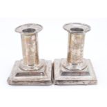 A pair of Victorian silver candle sticks, having detachable nozzles, weighted, (a/f), London 1875,