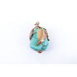 A turquoise nugget pendant, the stone captive within a 9 ct yellow metal mount modelled as