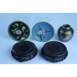 Two cloisonne dishes, together with a shakudo vase and two wooden stands, vase 7 cm