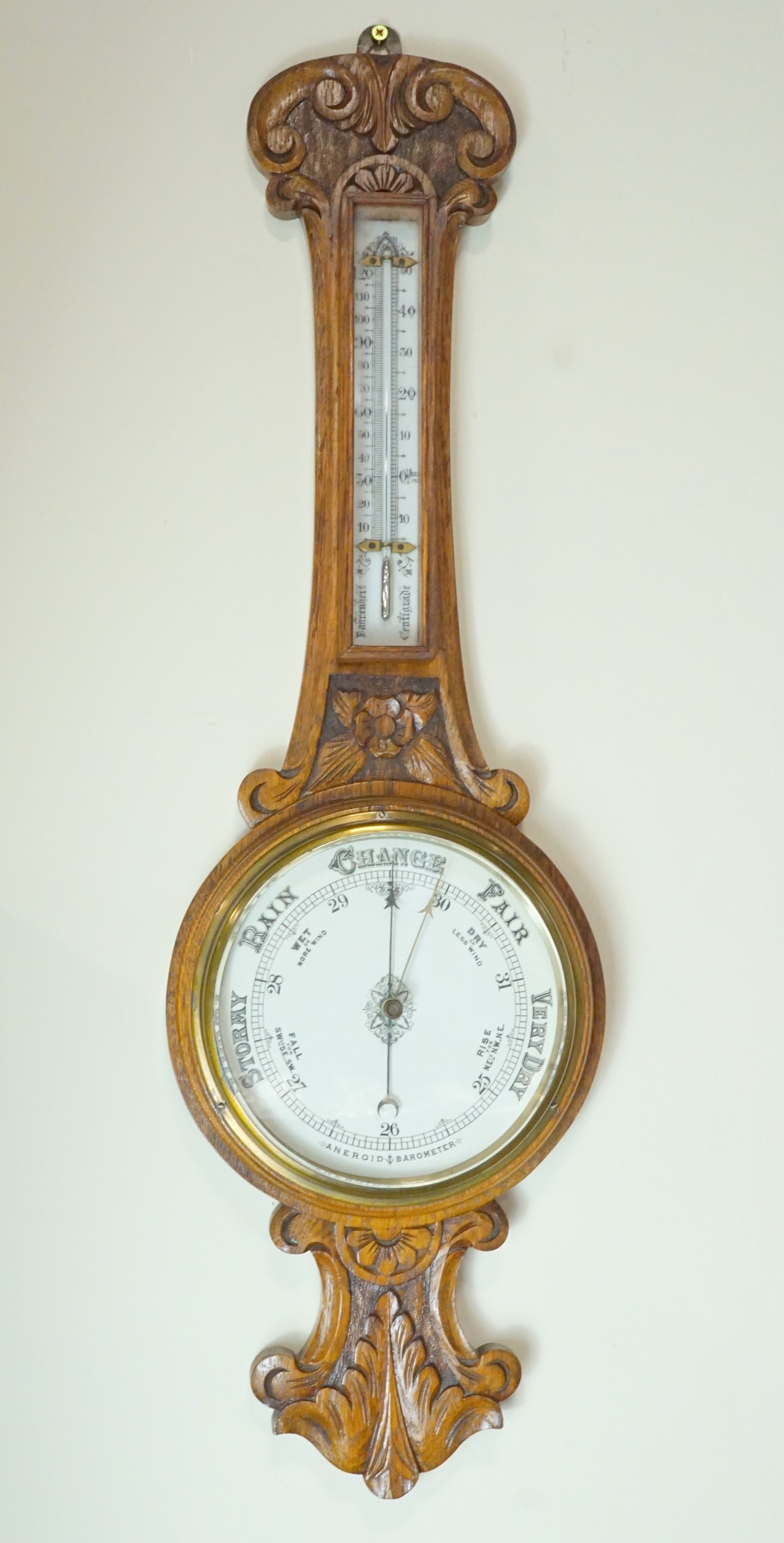 A late 19th / early 20th Century carved oak banjo aneroid barometer, 85 cm