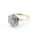 A seven-stone diamond daisy cluster ring, comprising round stones of approx .75 ct aggregate