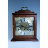 A contemporary Rapport mahogany mantle clock, 25 cm x 13 cm x 32 cm