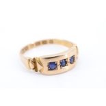 A Victorian lady's blue spinel ring, having three brilliant cut stones flush set in a line of square