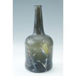 An 18th Century black glass wine bottle, 25 cm, (a/f)