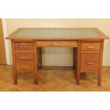 A 1940s - 1950s oak office desk, 143 cm x 81 cm x 77 cm