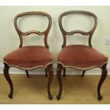 A pair of Victorian rosewood balloon-back dining chairs