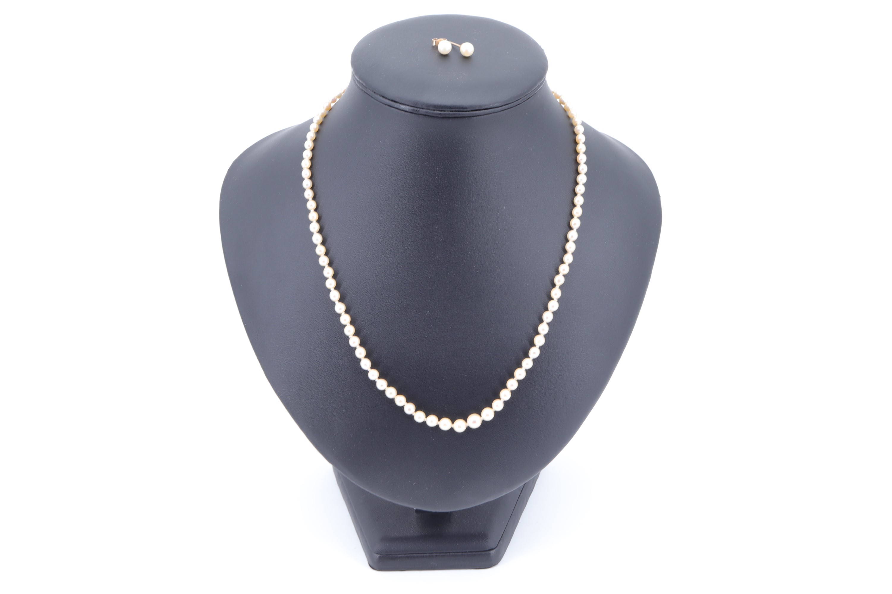 A 1950s pearl and diamond matinee necklace, graduated knotted cultured pearls, having a white