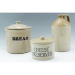 A stoneware flagon, 33 cm together with a bread crock and cheese preserver