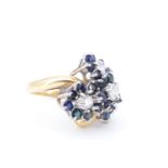An impressive sapphire and diamond cocktail ring, comprising a terraced trefoil arrangement of