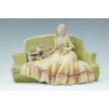 A kitsch painted plaster figurine of a lady with a dog, circa 1940s, 28 cm x 20 cm
