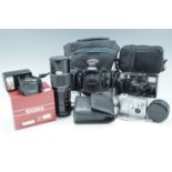 An Olympus OM 101 camera and flashgun, a Kodak Easyshare C340 camera, a Minolta AF-tele super