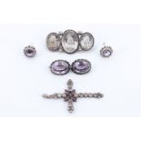 An early 20th Century amethyst and white metal demi parure of earrings and brooch, a rock crystal