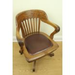 A late 19th / early 20th Century oak office revolving armchair