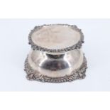 An Edwardian Carrington & Co silver inkwell, decorated with gadrooned and foliate mouldings,