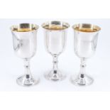 Three late Victorian silver wine goblets / chalices, having knopped stems, the bowls gilt, Thomas