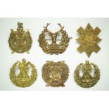A group of Scottish regimental brass cap badges