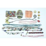 A quantity of vintage costume jewellery, comprising a horn butterfly pendant, hardstone necklaces,