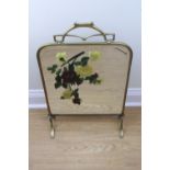 A late 19th / early 20th Century brass framed floral-enamelled mirror-fronted fire screen, 73 cm