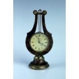 A Looping of Neuchatel Swiss desk or similar clock, of lyre form in lacquered and gilt brass,