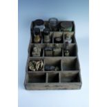 An early 20th Century wooden kitchen organiser with a group of vintage containers, bearing labels