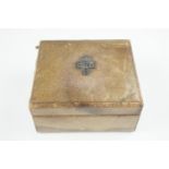 A pigskin covered table cigarette box, its lid bearing an affixed military badge, circa 1950s, 12 cm