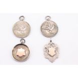 An Edwardian and George V silver watch chain fob medallions, together with two 1930s football