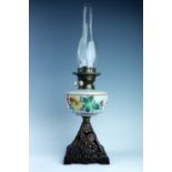 A Victorian oil lamp, having a hand enamelled milk glass reservoir, 56 cm