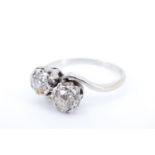 A vintage two-stone diamond ring, the old cut stones of approx 0.5 ct aggregate weight twist-set