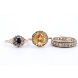 Three ladies' 9 ct gold rings, comprising a target set citrine ring, a daisy set blue and white